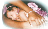 a woman is holding a baby in her arms