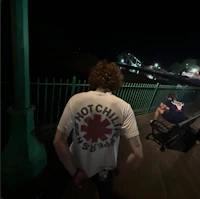 a man sitting on a bench at night
