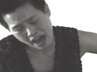 a black and white photo of a woman singing