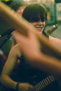 a woman playing a guitar in a bar