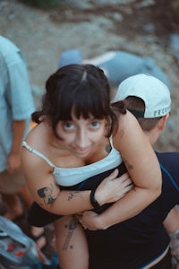 a woman is being carried by a man