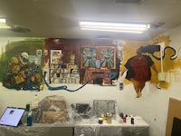 a room with a mural painted on the wall