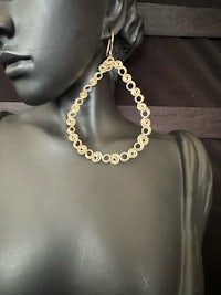 a mannequin mannequin wearing gold hoop earrings