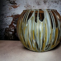a vase with yellow and white swirls on it