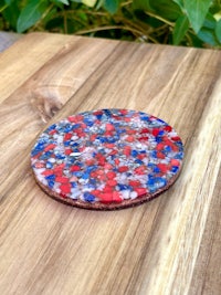 a red, white and blue coaster on a wooden table
