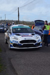 a ford focus rally car is parked on the side of a road