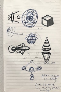 a notebook with various drawings on it