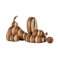 a wooden sculpture of a dog laying on a black background