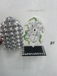 a person is making a piece of art on a wall