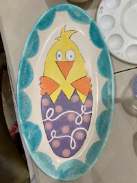 a plate with an easter chick painted on it