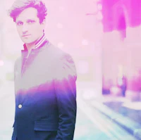 a man in a suit standing on a street