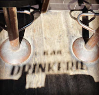 a shadow of a bar stools on a wooden floor