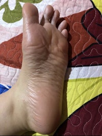 a person's foot on a quilt