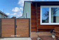 a wooden gate in front of a house