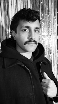 a black and white photo of a man with a mustache