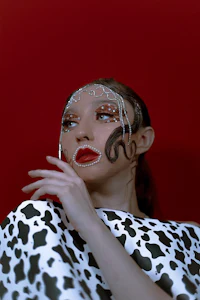 a woman wearing a polka dot dress and makeup