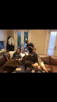 a group of people sitting on a couch in a living room