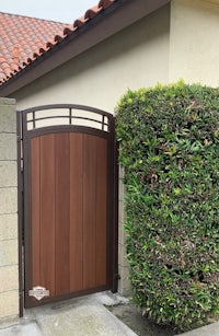 a wooden gate in front of a house