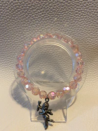 a pink swarovski bead holder on a white surface