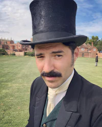 a man wearing a top hat and mustache