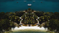 an aerial view of a tropical island with boats in the water