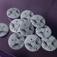 a group of tooth shaped buttons on a purple surface