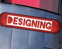 a red sign that says designing on the side of a building