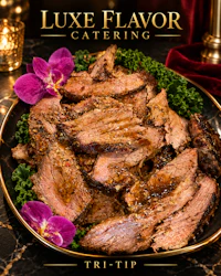 a plate of meat with the words luxe flavor catering trip