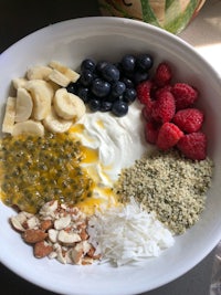 a bowl with yogurt, berries, bananas and nuts