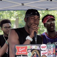 a man with a microphone in front of a group of people