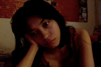 a girl laying on a bed with a cell phone in her hand