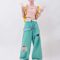 a girl wearing ripped denim pants and a striped t-shirt