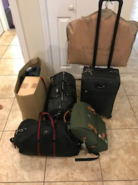 a group of luggage sitting on a tile floor