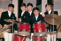 a group of young men posing with drums and saxophones