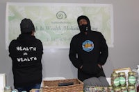 two people standing in front of a display of health products