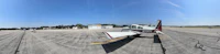 a fish eye view of an airplane parked on a runway