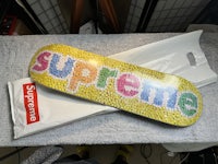 a skateboard with the word supreme on it