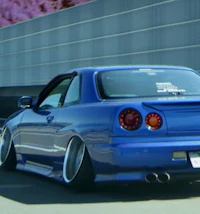 a blue car is driving down the road