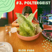 a woman is sitting at a table with a bowl of lettuce
