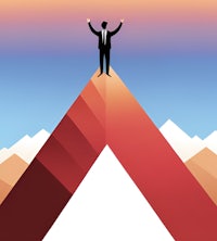 a businessman standing on top of a mountain with his arms raised