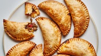 a plate with several empanadas on it