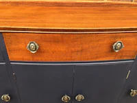 a blue sideboard with brass handles and knobs