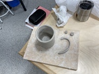 a ceramic mug on a tray with a cup on it