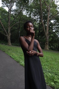 a woman standing in a wooded area