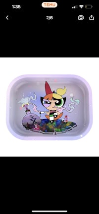 a powerpuff girl is sitting on a tray