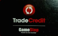 a trade credit game stop logo on a black background