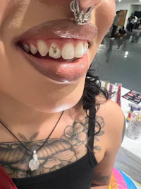 a woman with a tattoo on her face and teeth