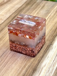 a small box with sand and stones on top