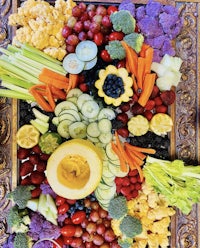 a tray of fruits and vegetables on a table