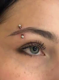 a woman with piercings on her eye